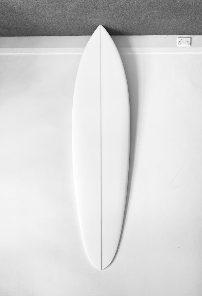 A sleek monochrome surfboard captured in a minimalist style, perfect for surf enthusiasts.